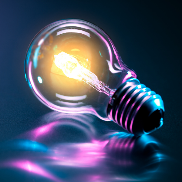 photo of a lightbulb reflecting neon purple